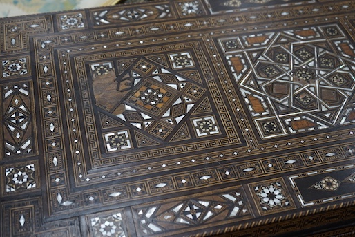 A 19th century Damascus mother of pearl, bone, and marquetry inlaid folding games table, with card, backgammon and chess surfaces, width 94cm, depth 47cm, height 85cm